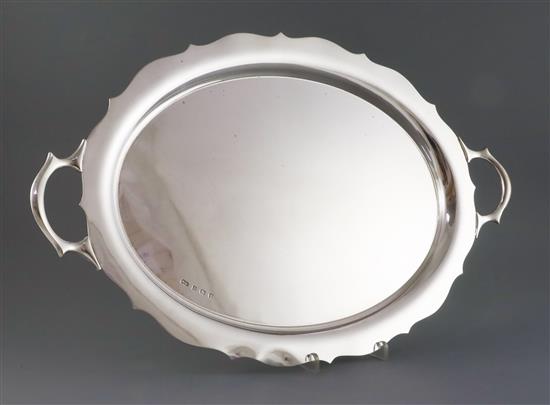 A George V silver two handled shaped oval tea tray, William Suckling Ltd, 58 oz.